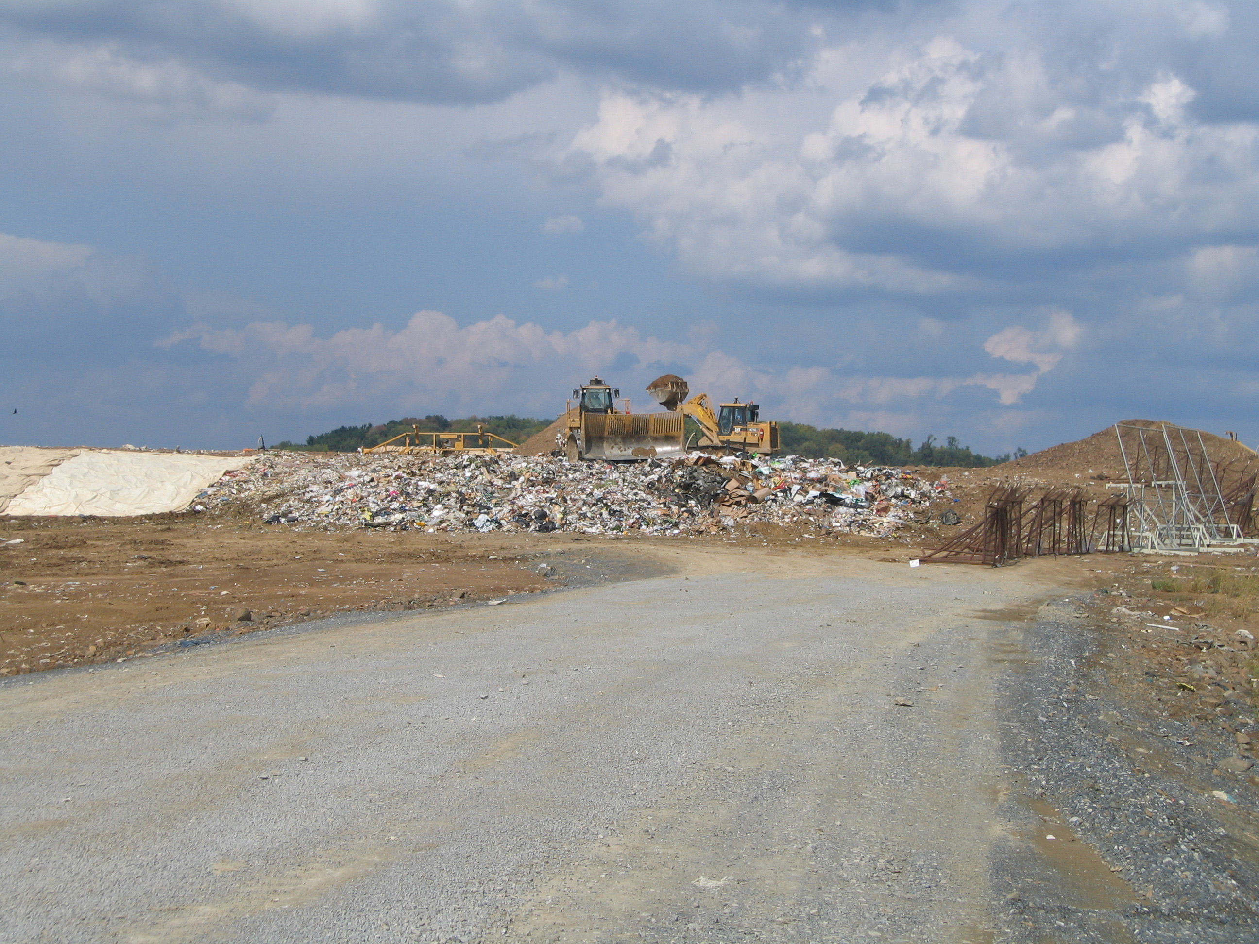 A bulldozer moving trash in the landfill