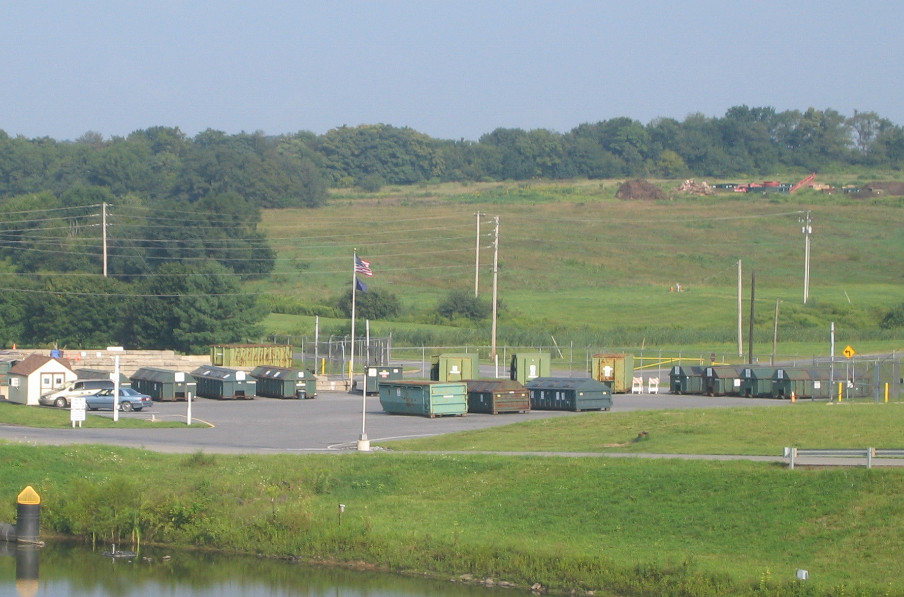 A lot with multiple green recycling containers