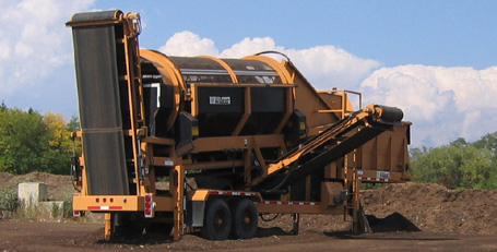 A trommel screen, basically a sizing machine, processes finished compost into into an aesthetically uniform end-product size